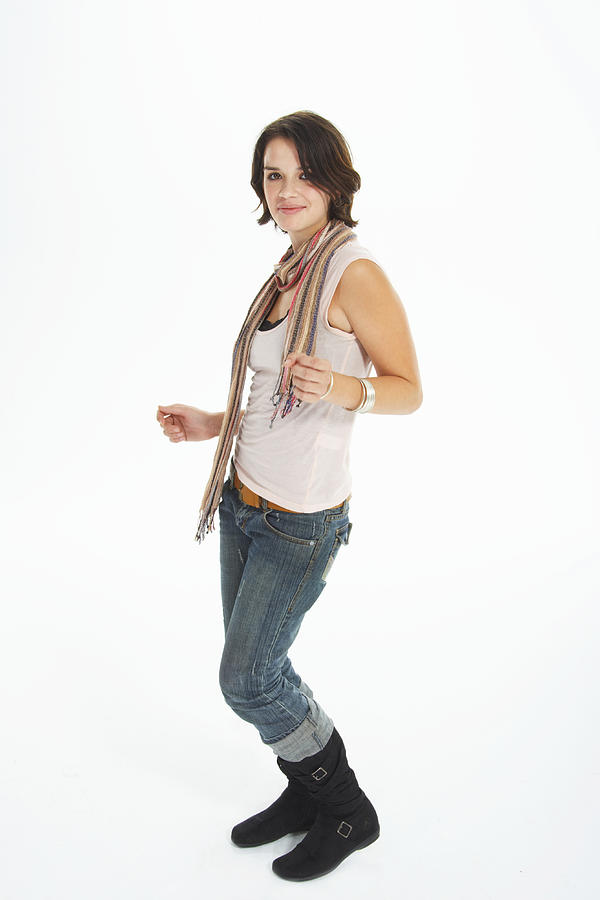 Teenage girl (16-18) dancing against white background, portrait Photograph by James Woodson