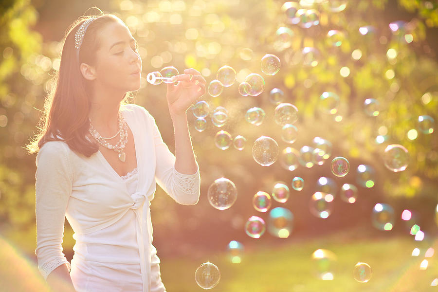 Teenage Girl Blowing Bubbles Photograph by Sasha Bell