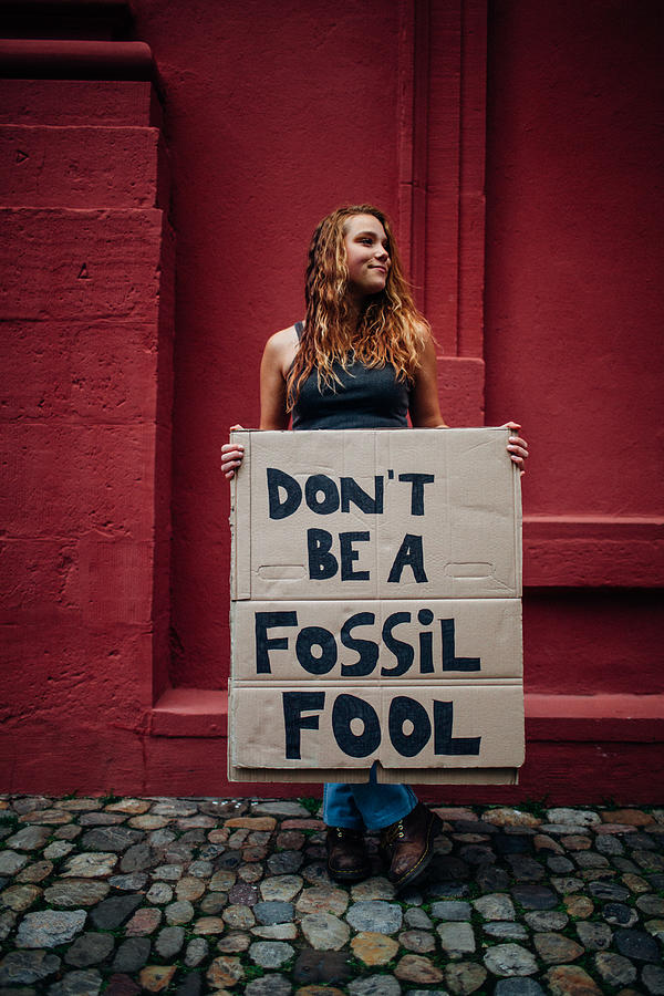 Teenage girl holding climate school strike protest sign Photograph by Counter