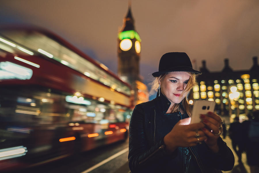 Teenage girl in London texting by night Photograph by Martin-dm