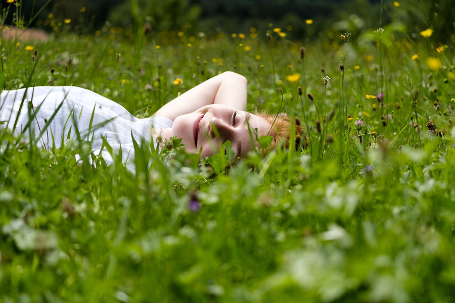 Teenage girl relaxing on a meadow Photograph by Westend61