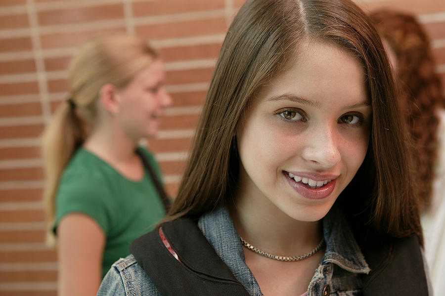Teenage girl smiling at school Photograph by Comstock Images
