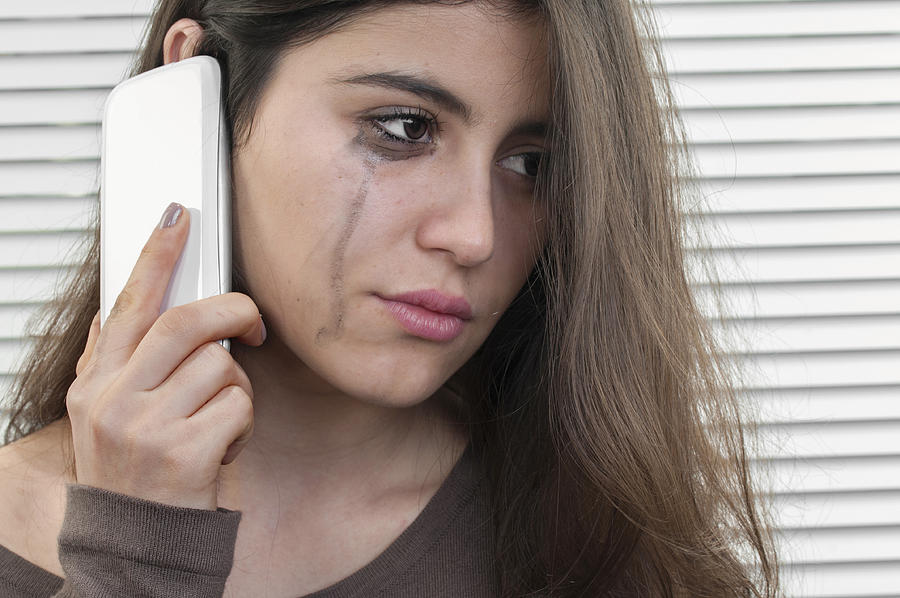 Teenage girl talking with mobile phone in depression Photograph by Mehmet Hilmi Barcin