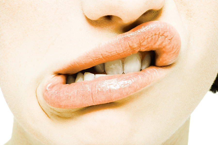 Teenage girl twisting mouth, extreme close-up Photograph by PhotoAlto/Alix Minde