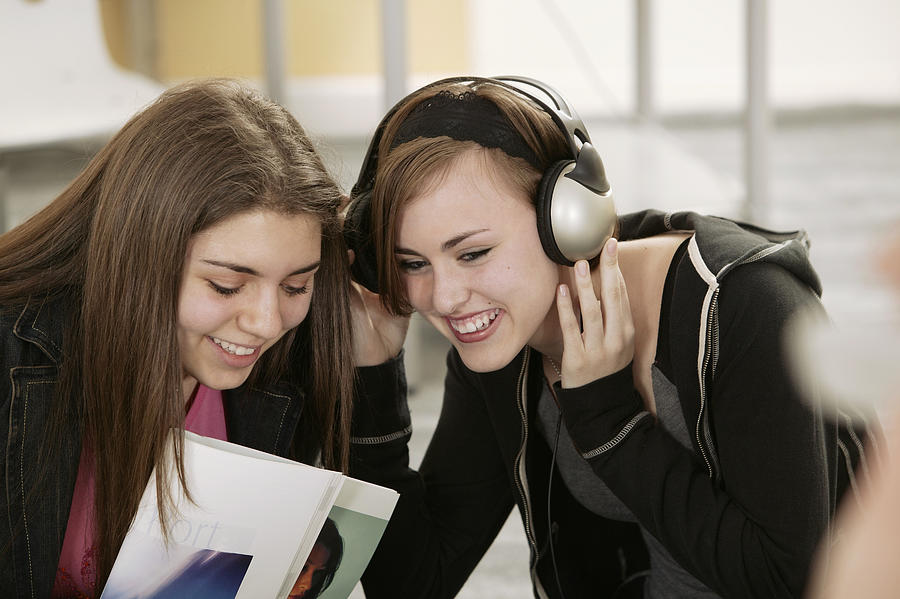 Teenage girls listening to music together Photograph by Comstock Images