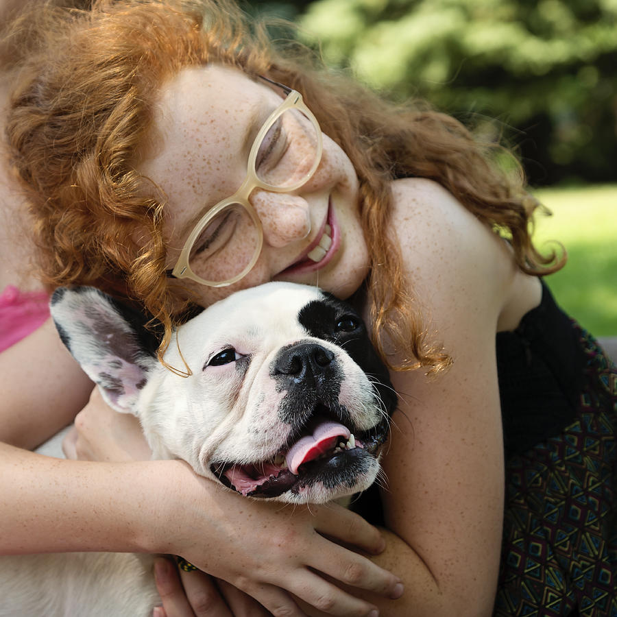 Teenage redhead girl in a park with a dog Photograph by Martinedoucet
