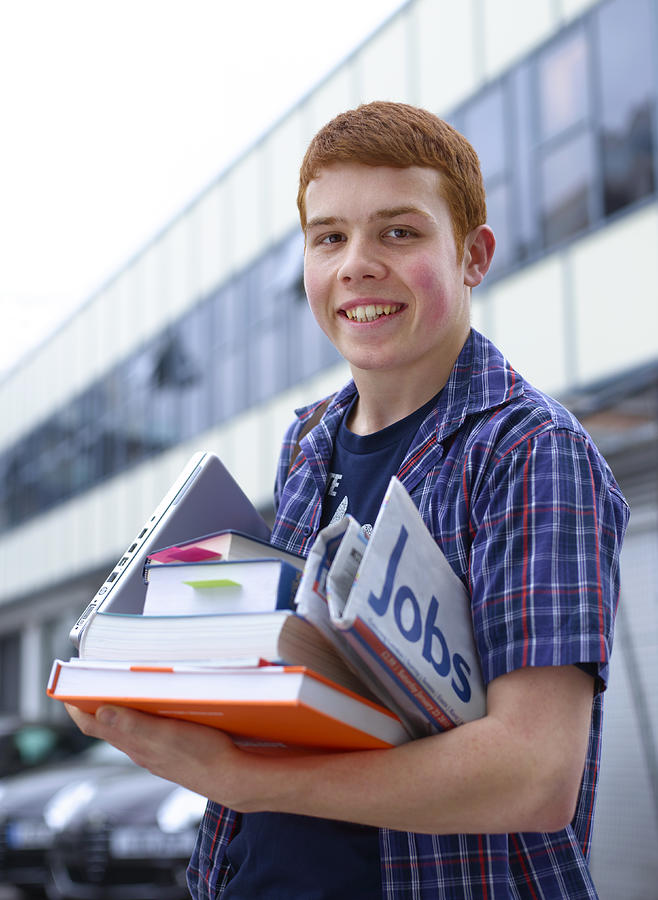 Teenage university student with jobs news paper Photograph by Peter Dazeley