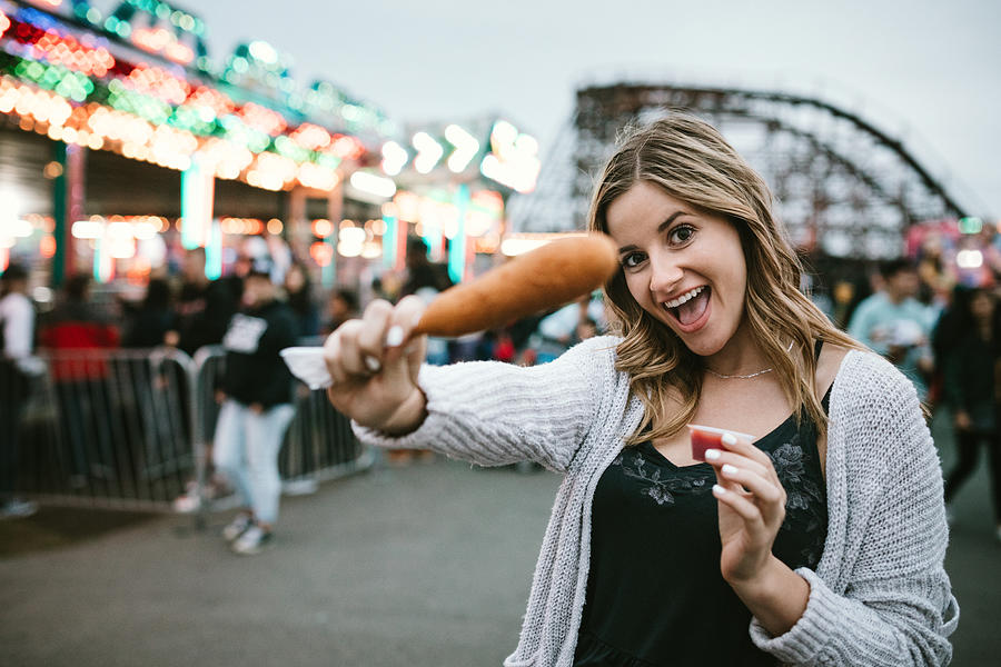 Teenage Woman Enjoying State Fair Food Photograph by RyanJLane