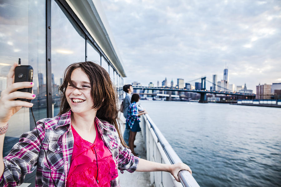 Teenager girl make selfie at ferry in front of Manhattan Photograph by Alex Potemkin