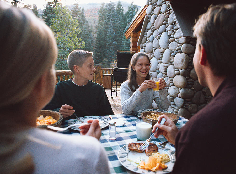 Teenagers Have Breakfast Outside At A Lodge Photograph by Photodisc