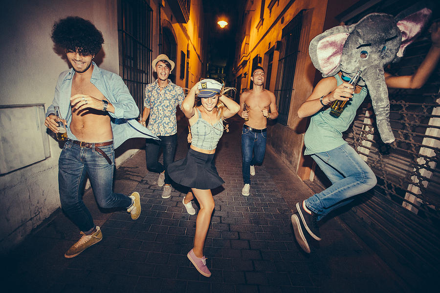 Teenagers Running Down Street During Night Party Photograph by Wundervisuals