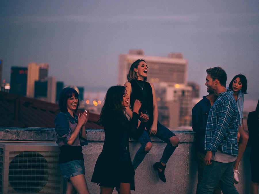 Teens celebrating a funny rooftop party Photograph by Wundervisuals