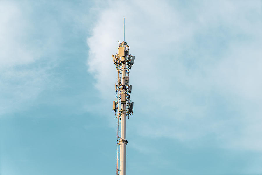 Telecommunications Tower with antennas on blue sky with cloud Photograph by Liyao Xie