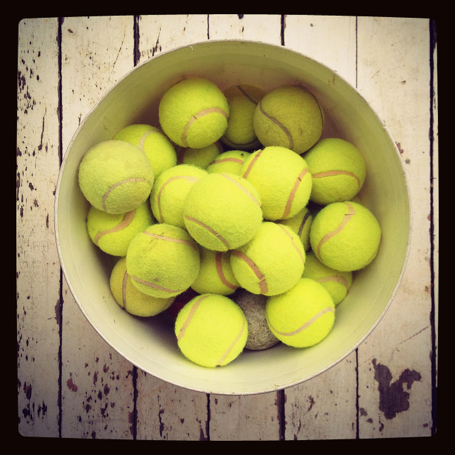 Tennis balls in bucket Photograph by Jodie Griggs