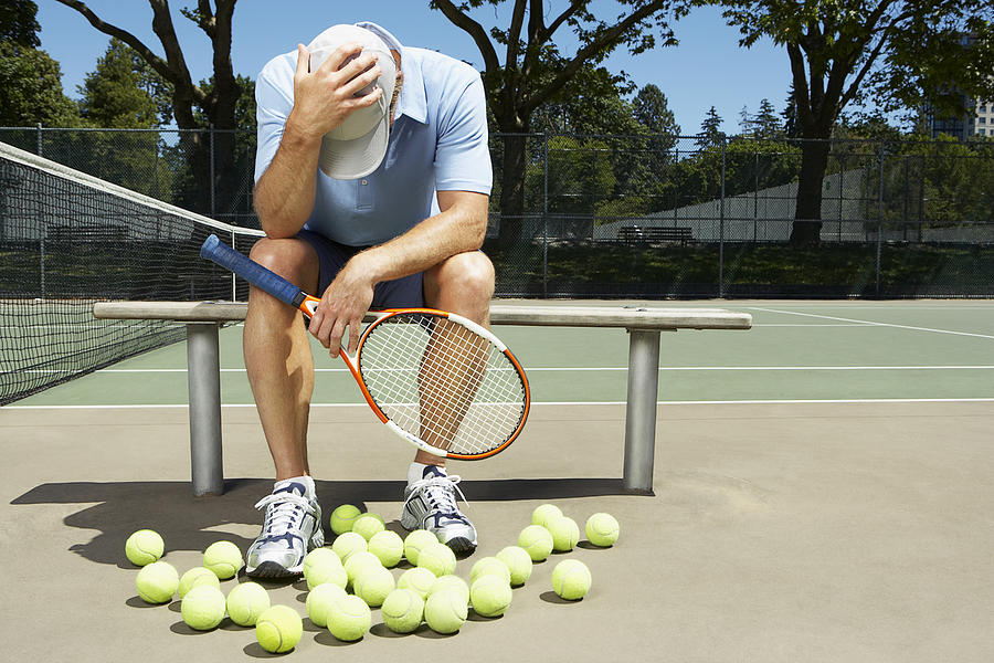 Tennis player with his head in his hands Photograph by FangXiaNuo