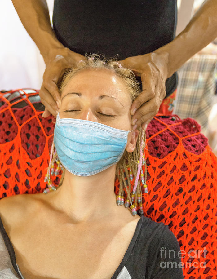 Thai facial massage with surgical mask Photograph by Benny Marty