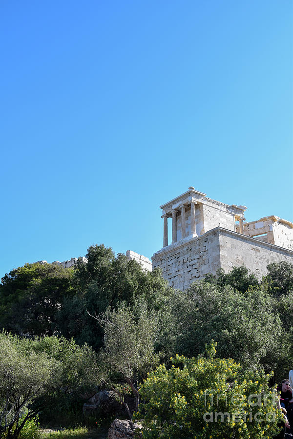 The ancient citadel of the Acropolis sits on a rocky hilltop abo Photograph by William Kuta