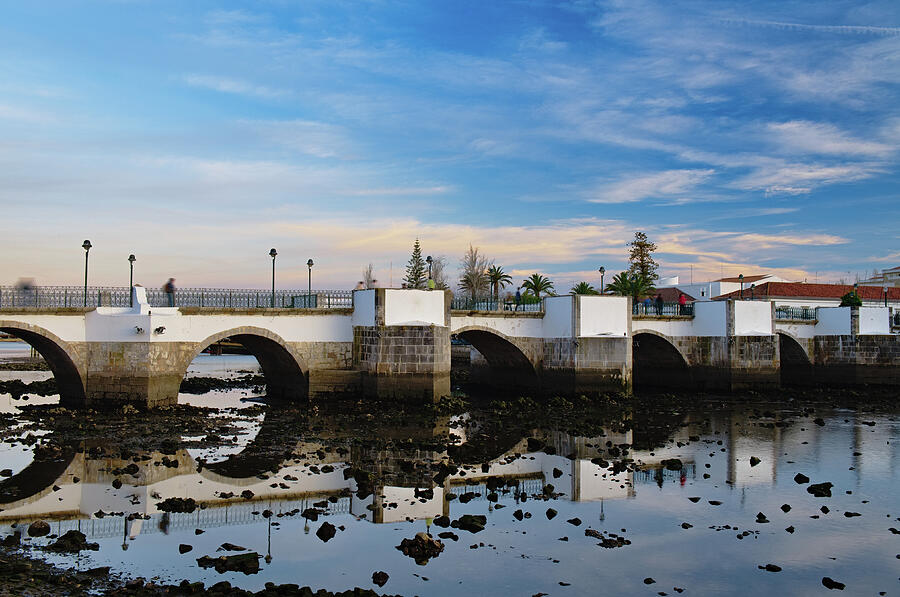 The antique bridge of Tavira. Portugal Photograph by Angelo DeVal