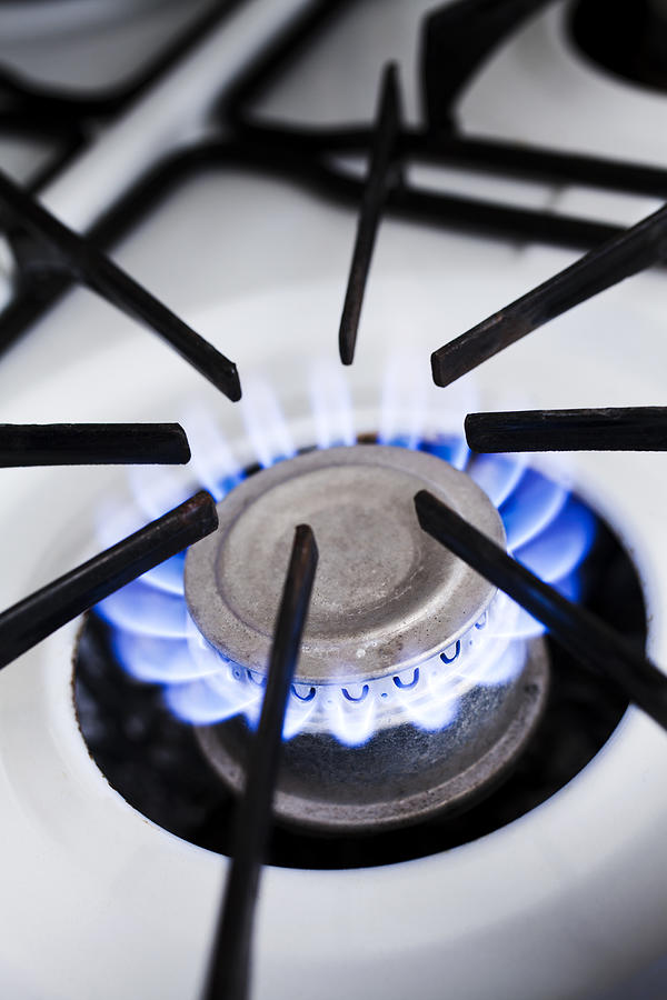 The blue flame of a lit gas stove burner, close-up Photograph by Epoxydude