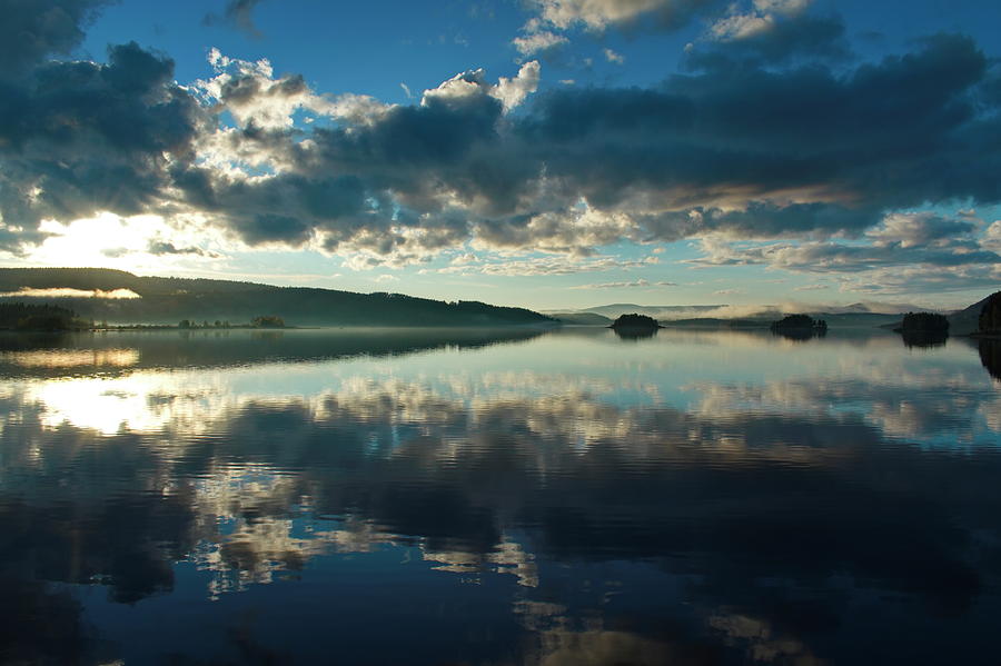 The blue sky and towering clouds are reflected in a quiet lake Photograph by Ulrich Kunst And Bettina Scheidulin