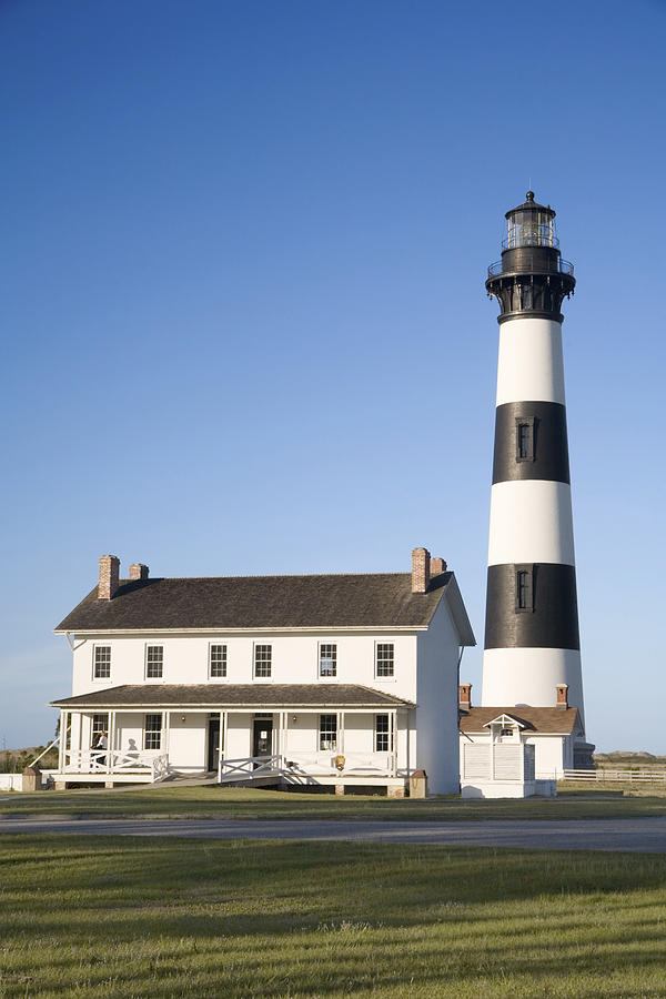 The Bodie Island Lighthouse and keepers quarters on Cape Hatteras National Seashore, North Carolina Outer Banks. Photograph by Uyen Le
