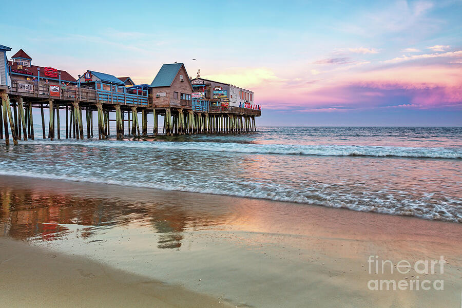 The busy pier of Old Orchard beach, Portland, Maine, at sunset. A popular location for family vacations in the sand and sunshine of New England. Photograph by Jane Rix