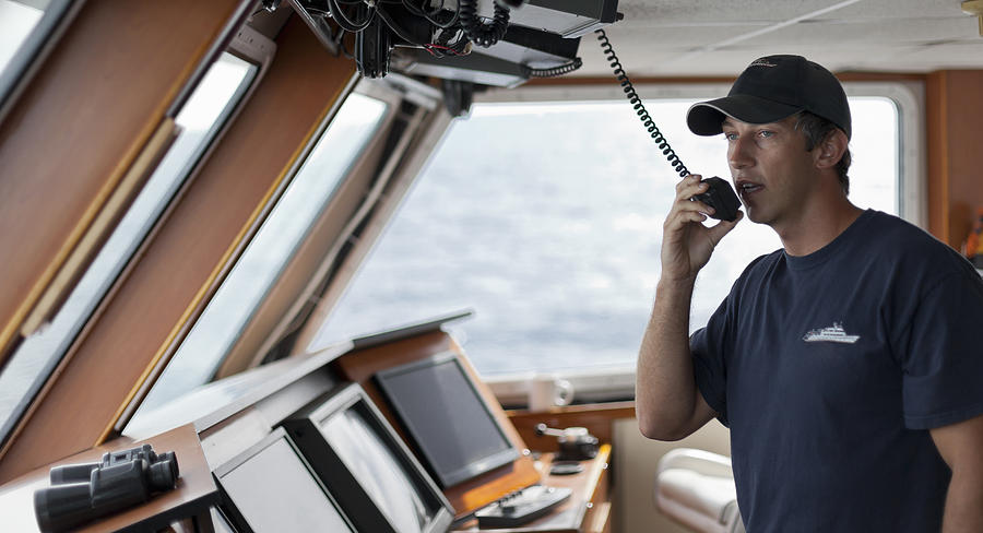 The captain uses a radio from the bridge of a boat Photograph by Noel Hendrickson