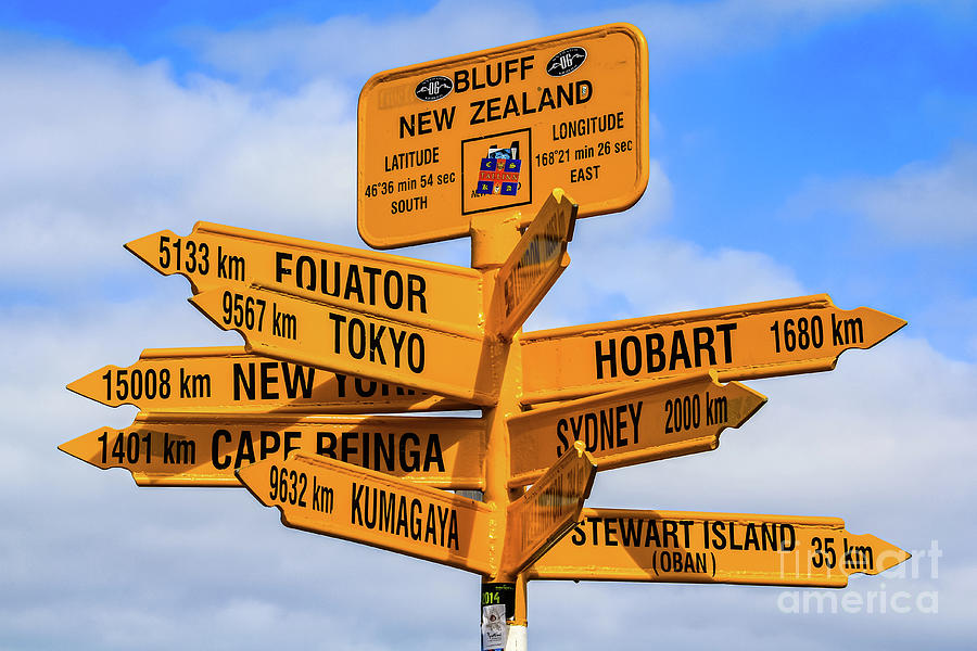 The end of the road - signpost at Stirling Point, Bluff, New Zealand Photograph by Lyl Dil Creations