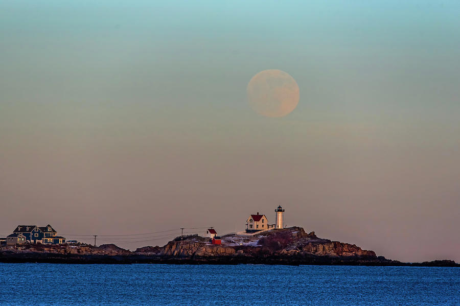 The full moon rises over the Nubble Lighthouse York Beach Cape Neddick Maine Sunset Photograph by Toby McGuire