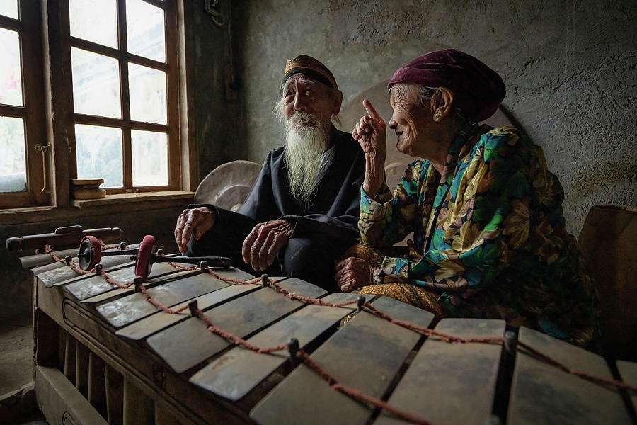 The gamelan maestro with his wife having a laugh Photograph by Anges Van der Logt