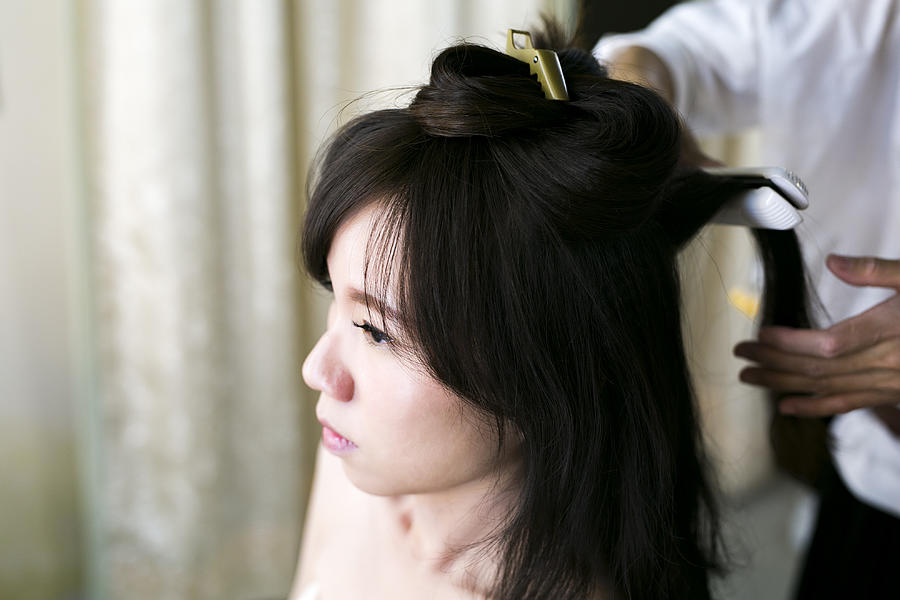 The hairdresser make the hair bun Photograph by Ivan
