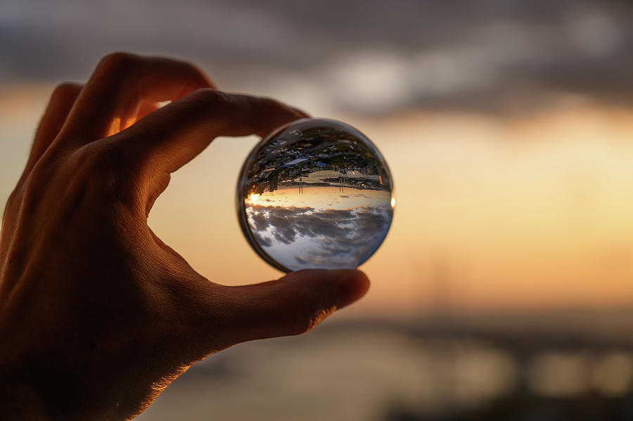 The hand holds glass ball. Photograph by Vladimir Arndt - Pixels