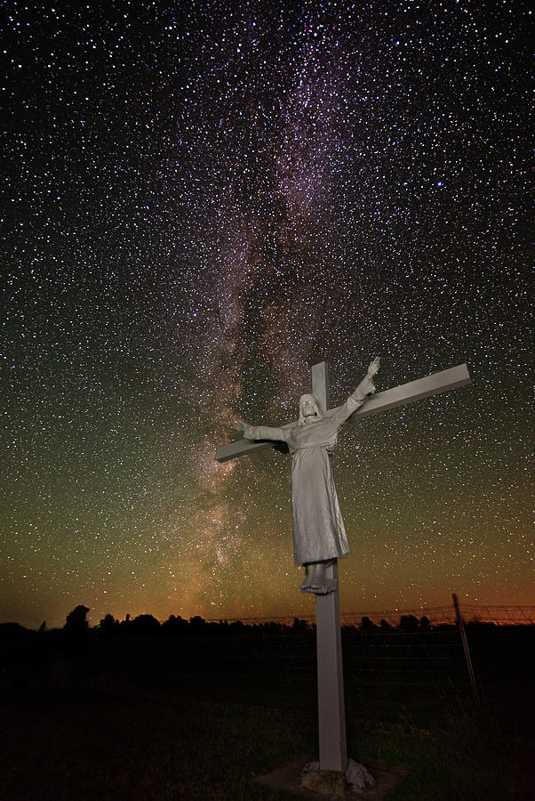 The Heavens Declare -  Jesus with raised arms on cross in front of Milky Way Photograph by Peter Herman