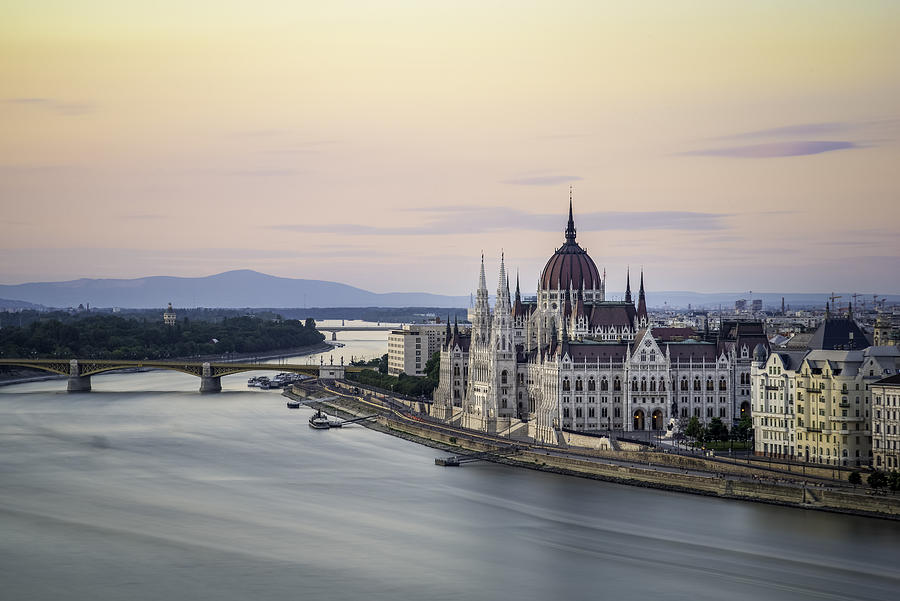The Hungarian Parliament Building on the Banks of the Danube at dawn Photograph by Copyright. Sasipa Muennuch.