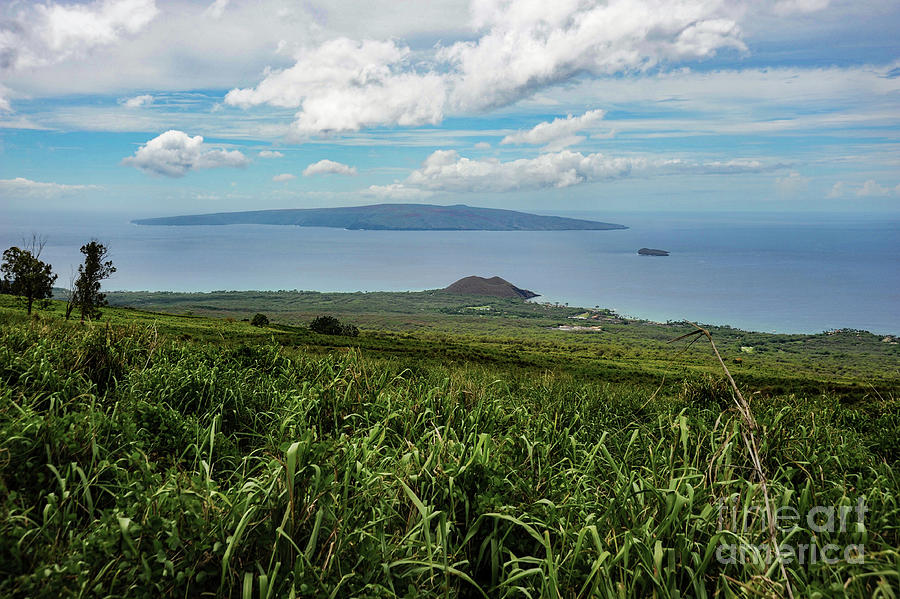 The island of Lanai in the Distance from Maui, Hawaii with sugar cane fields in the foreground.  Photograph by Gunther Allen