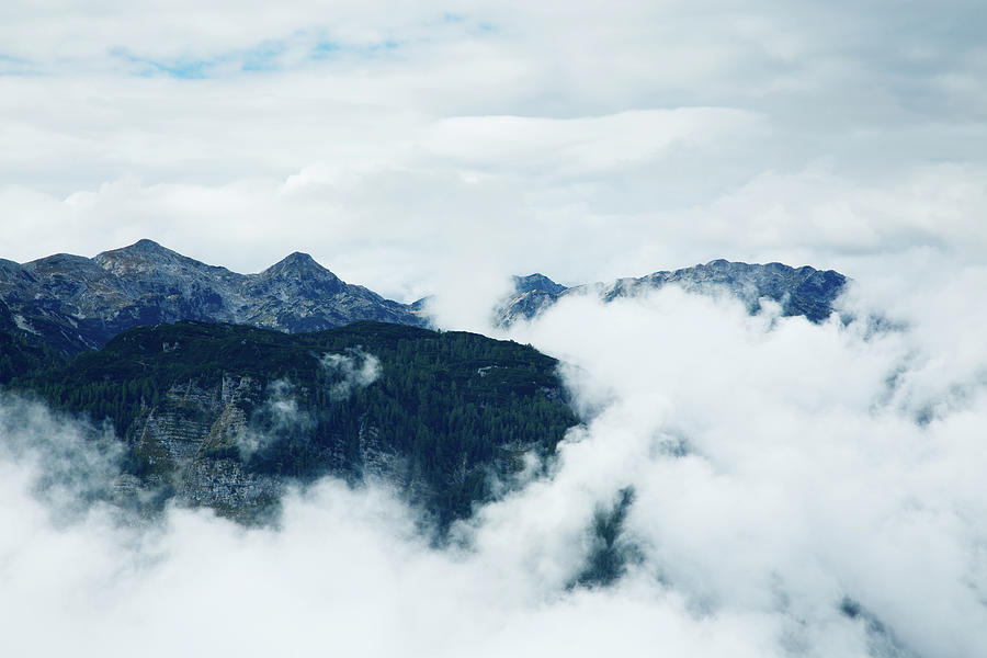 The Julian Alps breaking through the clouds Photograph by Ian Middleton