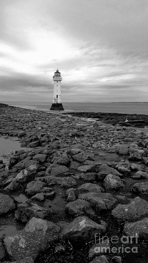 The Lighthouse On The Rocks In Monochrome Photograph