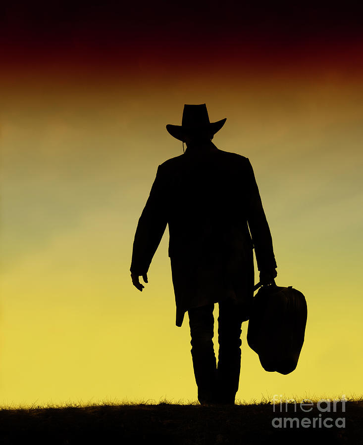 Sunset Photograph - The Lonesome Cowboy Walking into the Sunset by Nina Stavlund
