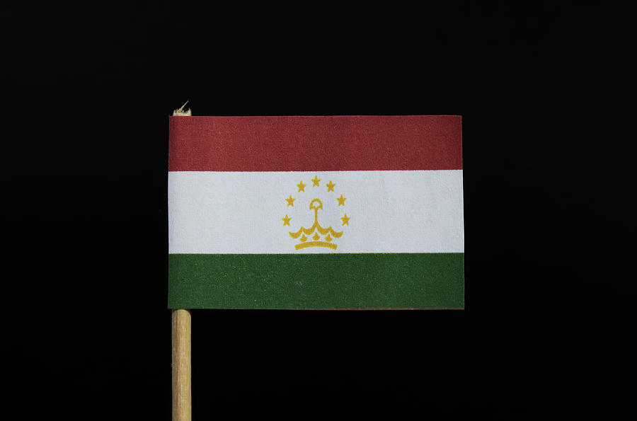The national flag of Tajikistan on toothpick on black background. A horizontal tricolor of red, white and green Photograph by Vaclav Sonnek