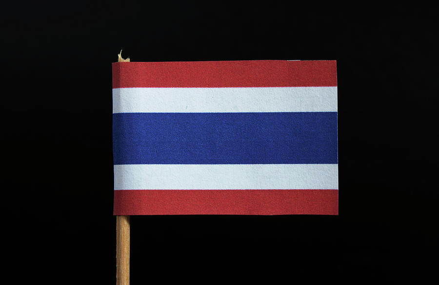 The national flag of the Kingdom of Thailand on toothpick on black background. Five horizontal stripes of red, white, blue, white and red, the middle stripe twice as wide as the others Photograph by Vaclav Sonnek