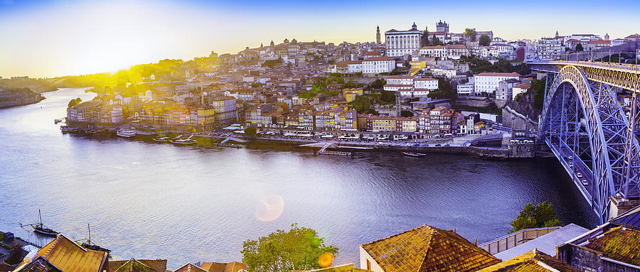 The Ribeira in Porto with a sunset and sunflare Photograph by Thegift777