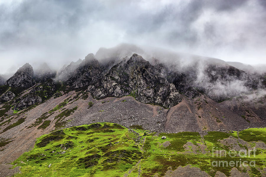 The rugged peaks of Mount Snowdon, Snowdonia National Park, North Wales, UK. Low hanging cloud and lush grass landscape. Photograph by Jane Rix
