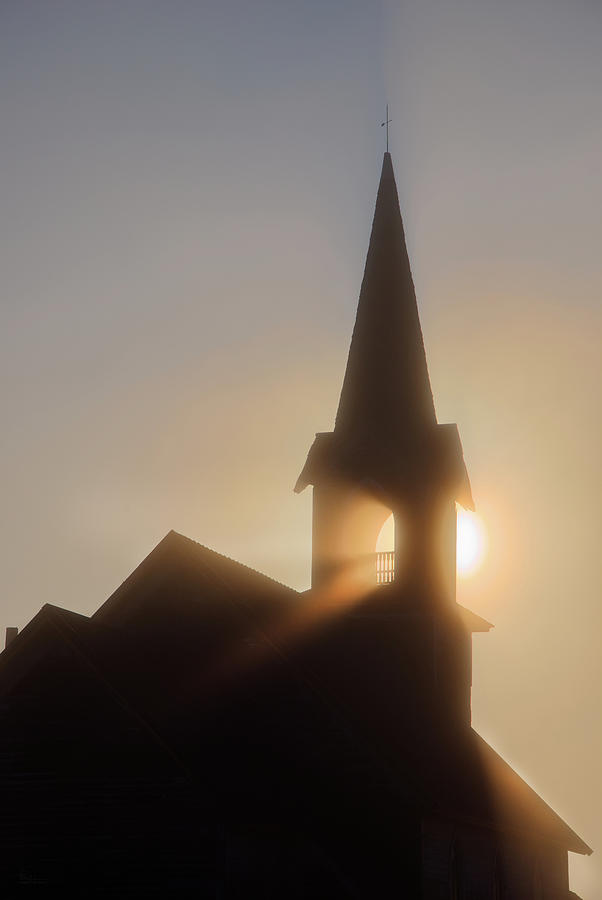 The Sons Lighthouse - sun rays in fog through steeple of abandoned  Lutheran church  Photograph by Peter Herman