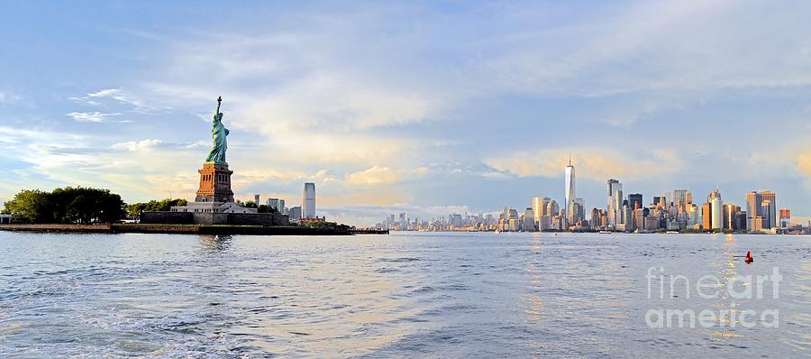 The Statue of Liberty Surveys New York Harbor With The Skyline Of Manhattan.. Photograph by Tom Wurl