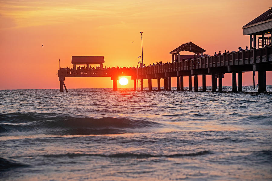 The Sunset Draws a Crowd at the Clearwater Beach Pier Clearwater Florida Sun Through the PIer Photograph by Toby McGuire