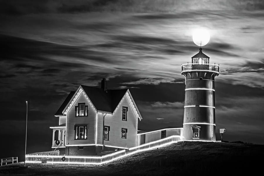 The supermoon rising over the top of the Nubble Lighthouse York Maine Black and White Photograph by Toby McGuire