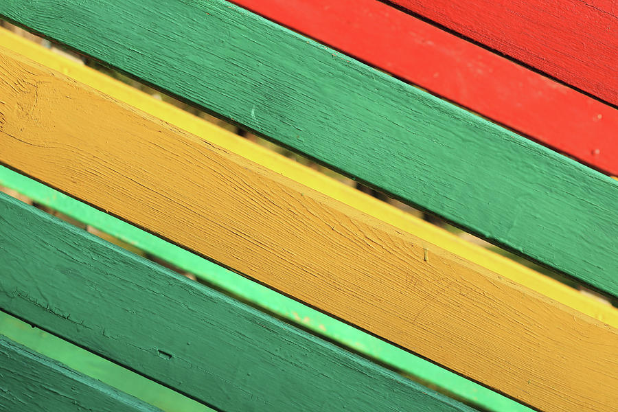 The surface of the nailed boards painted in green, yellow and red ...