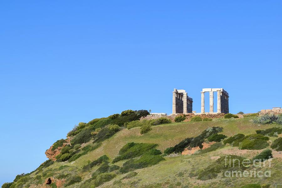 The Temple of Poseidon sits on a hilltop on Cape Sounion, Attica, Greece Photograph by William Kuta