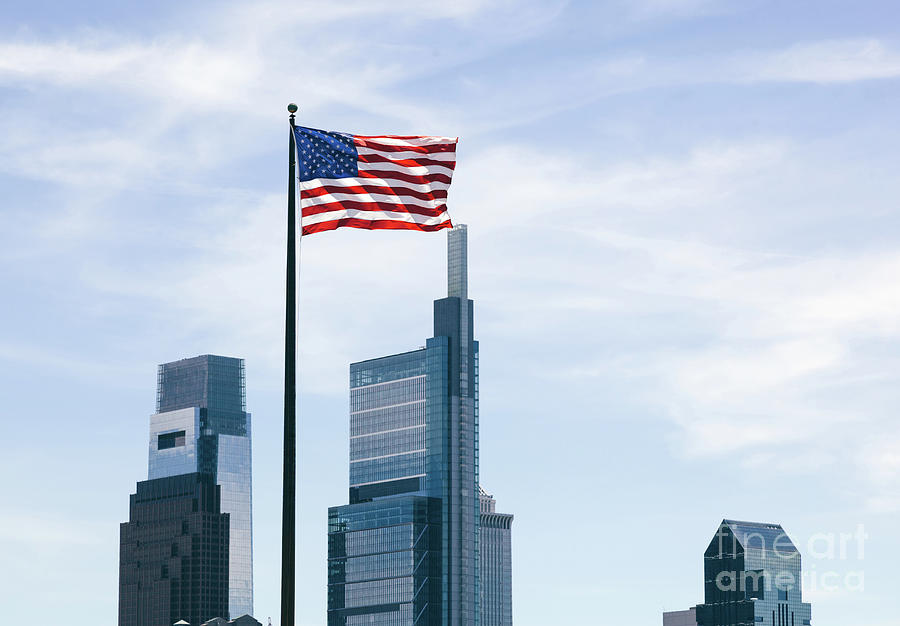 The USA flag overlooking skyscrapers background. Photograph by Michal Bednarek