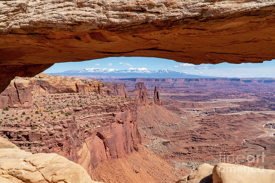 The Washerwoman Arch is framed by the Mesa Arch at Canyonlands N Photograph by William Kuta